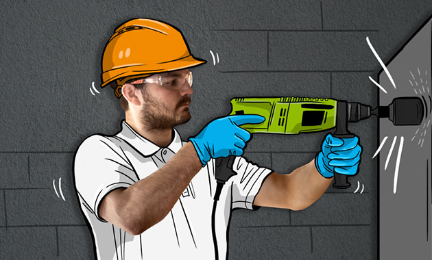 Handwerker mit einem Bohrhammer und Tresor